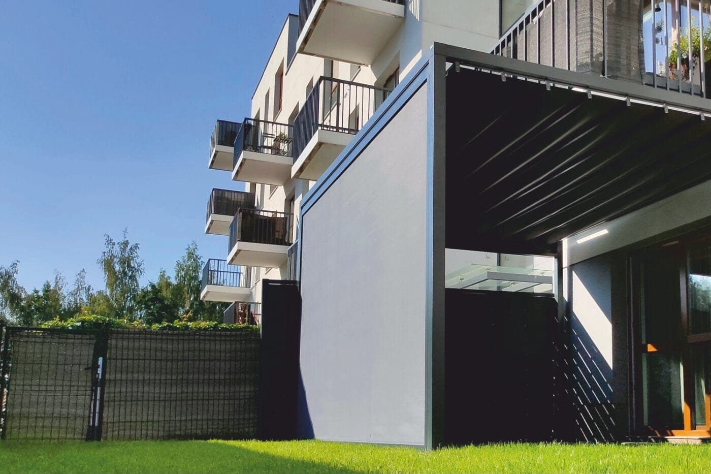 Close-up of ZIP screen fabric held in side guide rails on a modern exterior